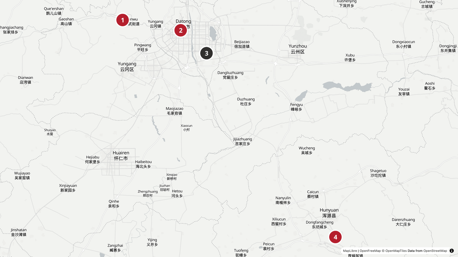 Carte de Datong et de ses deux grands sites : les grottes de Yungang à quatorze kilomètres à l'ouest de la ville, la vieille ville et ses remparts au centre, la gare de Datong-Sud au sud-est, et le monastère suspendu de Xuankong à une soixantaine de kilomètres au sud-est