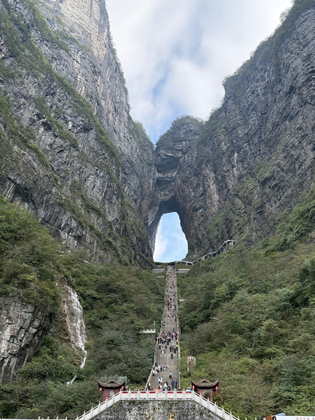 La porte du Ciel de la montagne Tianmen, arche naturelle laissant voir le ciel bleu, au sommet d'un long escalier