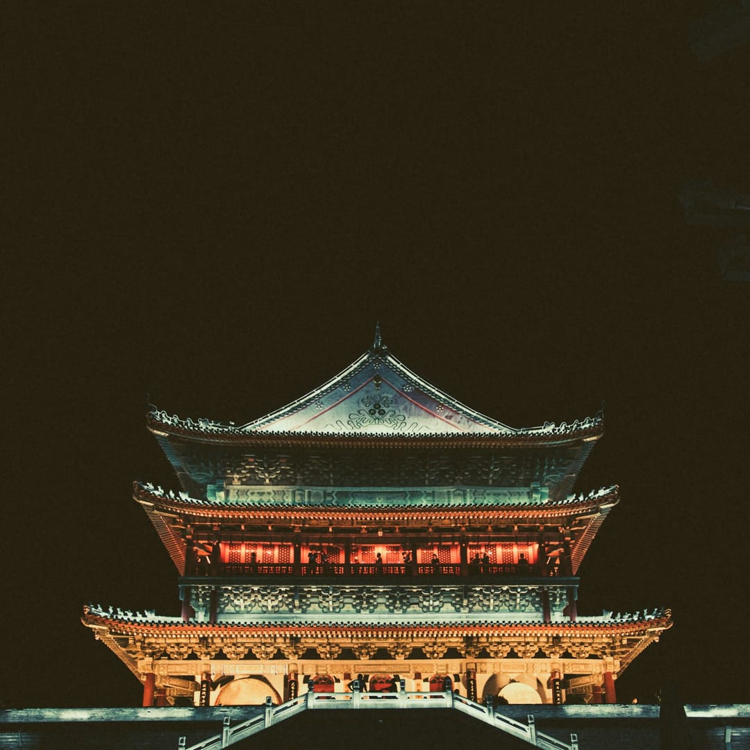 Tour impériale chinoise à toits recourbés et lanternes rouges, illuminée la nuit, au centre de Xi'an